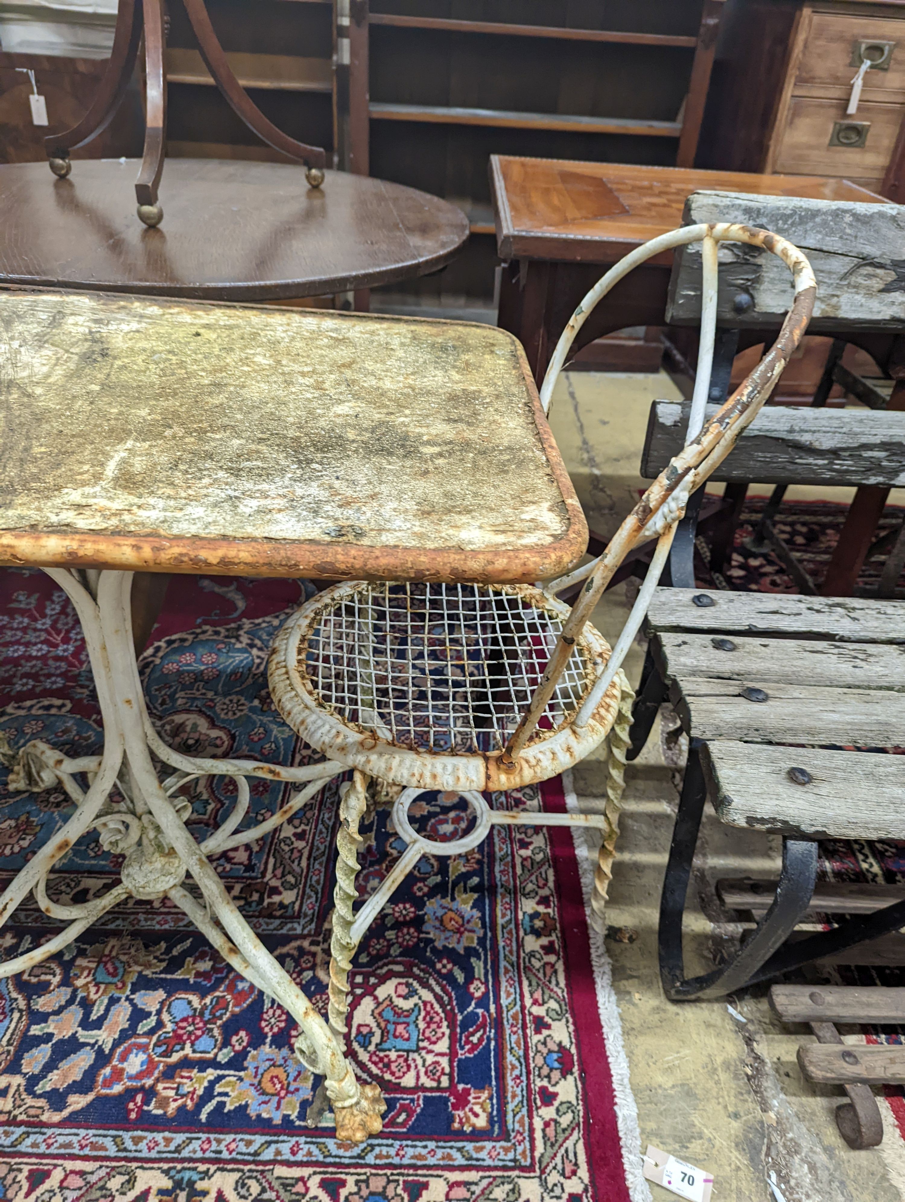 A rectangular French wrought iron garden table, length 80cm, depth 49cm, height 70cm and two chairs